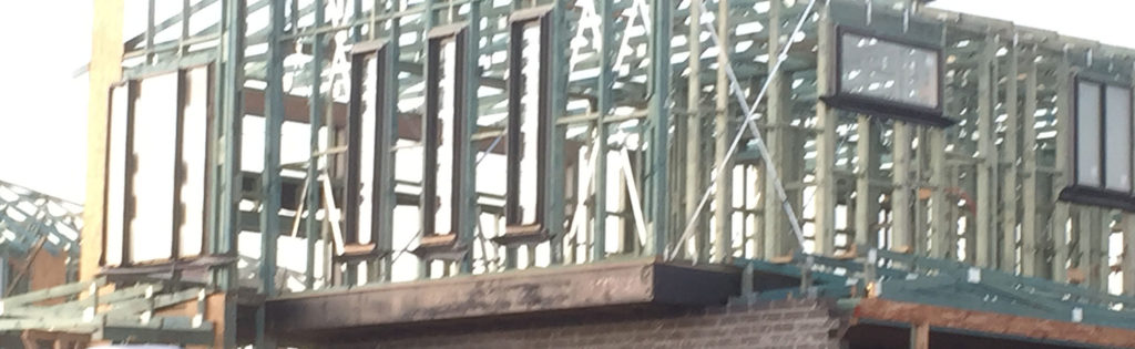 Frames rising along the street at Grantham Farm